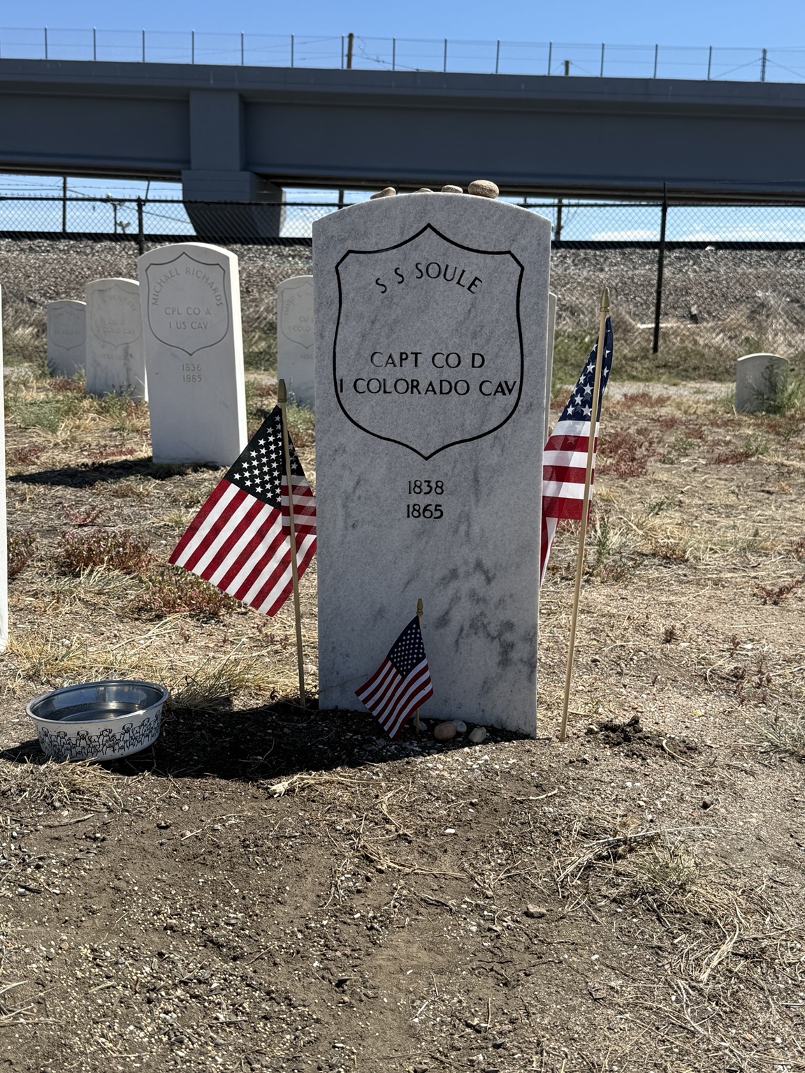 Silas S. Soule’s military headstone at Riverside Cemetery in Denver, decorated with American flags